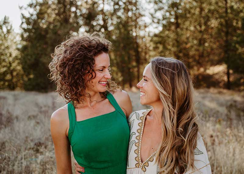 deux amies dans la nature en train de se regarder dans les yeux avec compassion